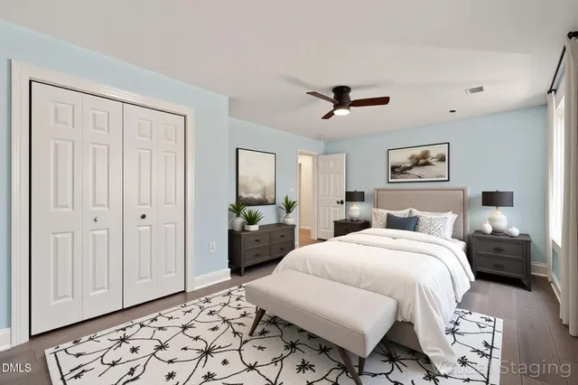 a view of an empty room with wooden floor stairs and a way to kitchen