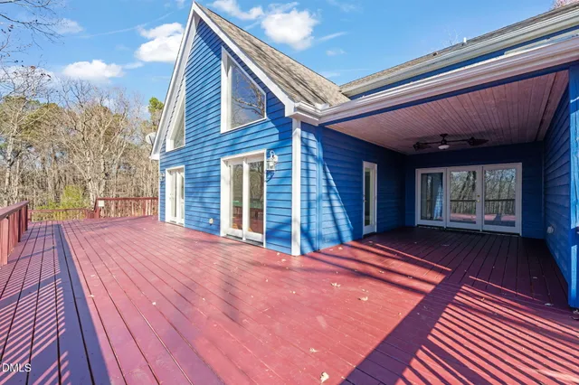 a view of a house with a wooden fence