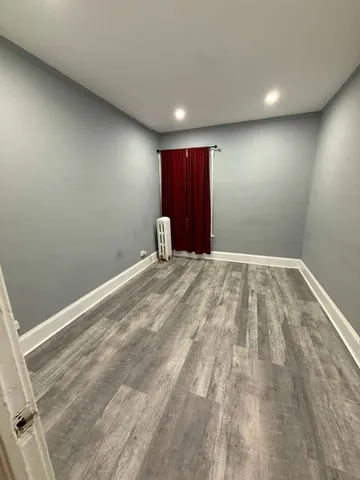 a view of a livingroom with wooden floor and window