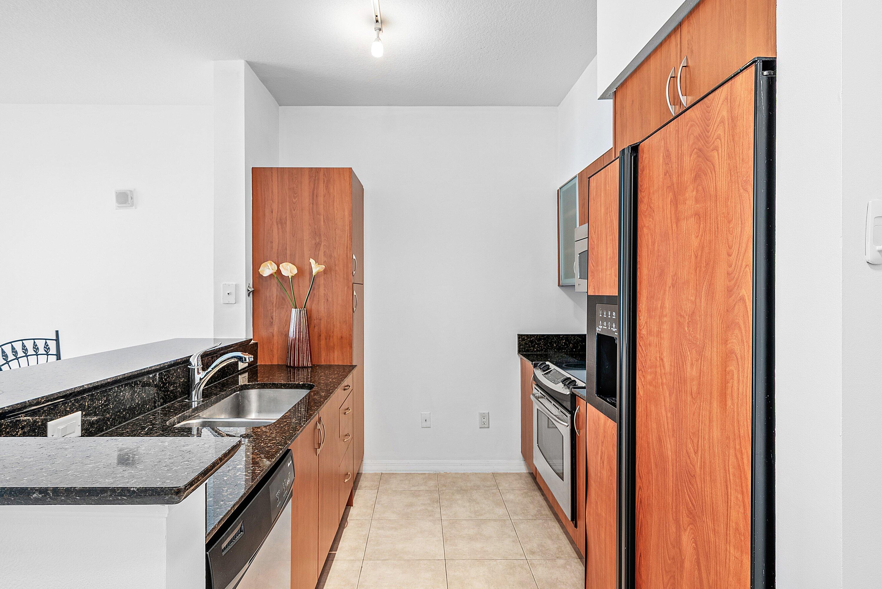 233 South Federal Highway, Unit 404 Boca Raton, FL 33432 - Photo 8 of 34 a kitchen with a sink and a stove