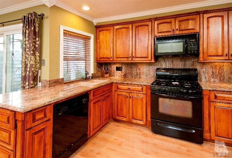 13452 East Quail Summit Road Moorpark, CA 93021 - Photo 3 of 15 a kitchen with granite countertop a stove and a sink