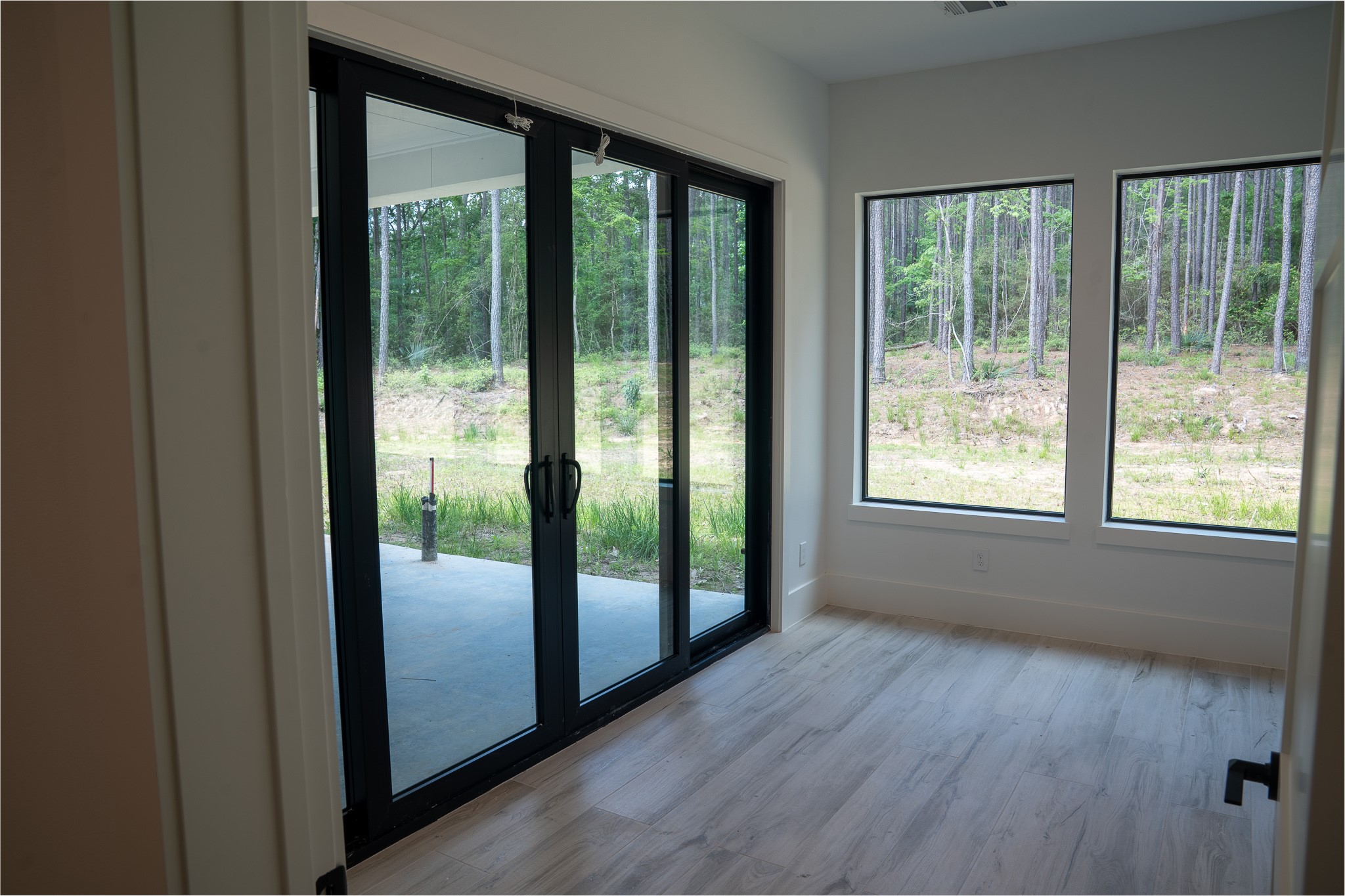 343 Sundog Road Huntsville, TX 77340 - Photo 15 of 37 Flex room with glass doors leading to the covered back porch. This space can be used for various activities and seamlessly connects the indoor and outdoor living areas.