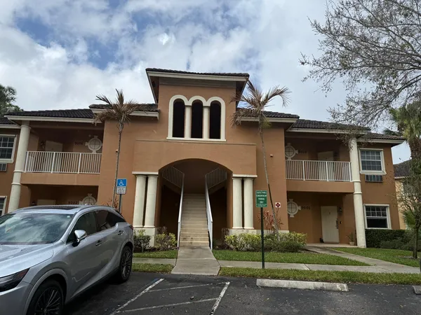 a view of a car parked in front of a brick house