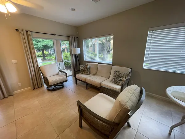 a view of a kitchen with kitchen island a dining table chairs and a sink