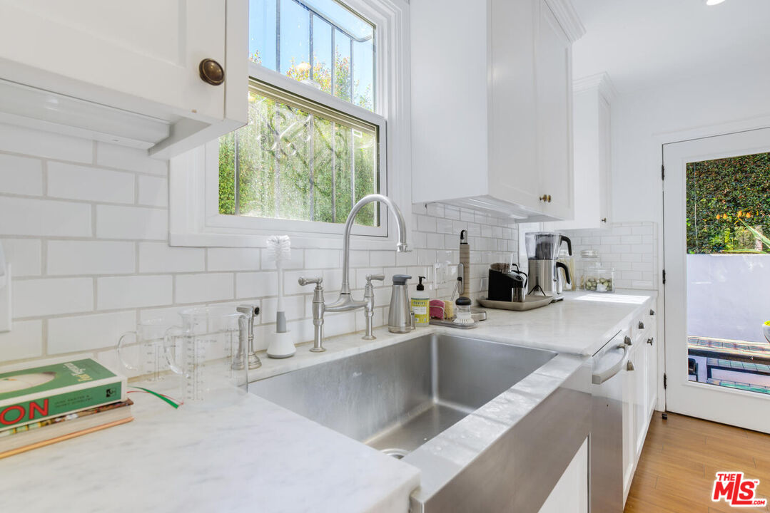 1417 Queens Road Los Angeles, CA 90069 - Photo 11 of 25 a kitchen with a sink and a stove top oven