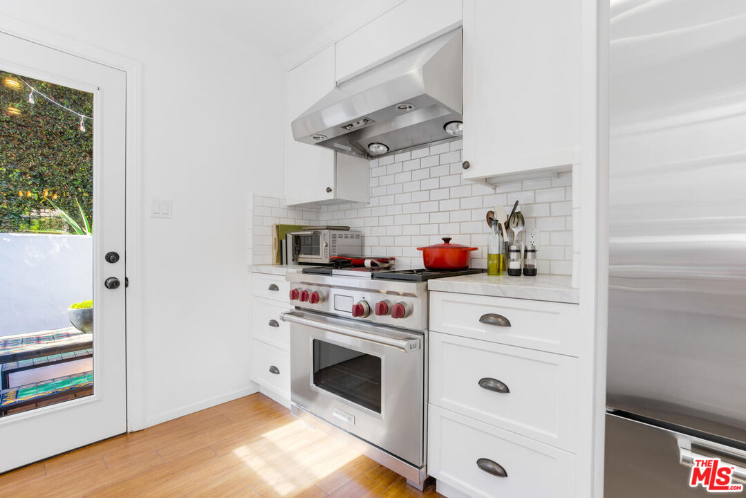 1417 Queens Road Los Angeles, CA 90069 - Photo 12 of 25 a kitchen with stainless steel appliances white cabinets and a stove