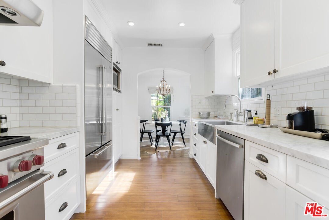 1417 Queens Road Los Angeles, CA 90069 - Photo 13 of 25 a kitchen with granite countertop a refrigerator stove top oven and sink