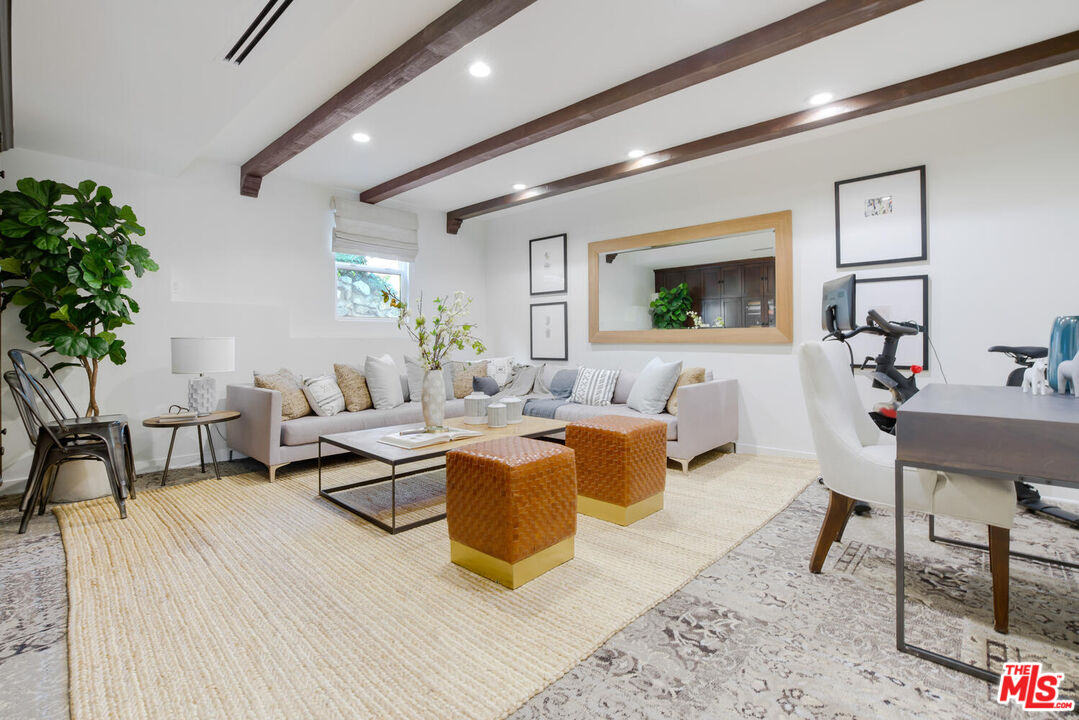 1417 Queens Road Los Angeles, CA 90069 - Photo 15 of 25 a living room with furniture and a flat screen tv