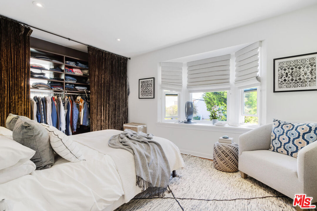 1417 Queens Road Los Angeles, CA 90069 - Photo 16 of 25 a bed sitting in a bedroom next to a window