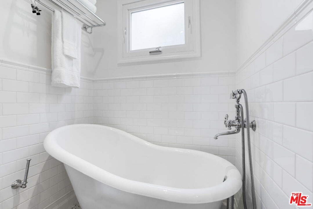 1417 Queens Road Los Angeles, CA 90069 - Photo 18 of 25 a white bath tub sitting next to a white sink and vanity