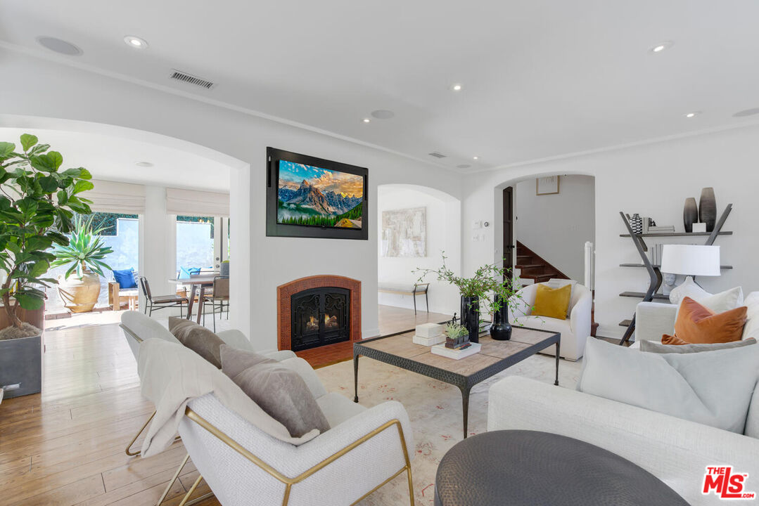 1417 Queens Road Los Angeles, CA 90069 - Photo 6 of 25 a living room with furniture potted plant and a fireplace