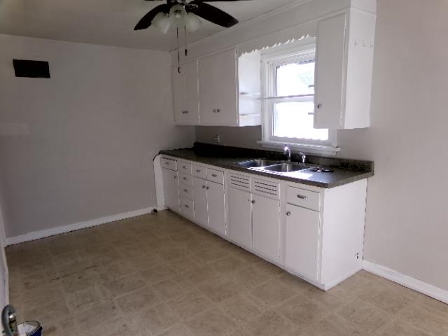 321 West Garfield Street Freeport, IL 61032 - Photo 2 of 11 a kitchen with a sink stove and cabinets