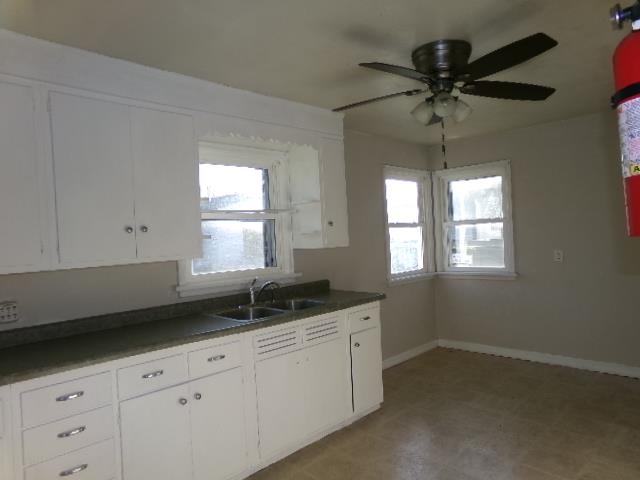 321 West Garfield Street Freeport, IL 61032 - Photo 3 of 11 a kitchen with a sink window and cabinets