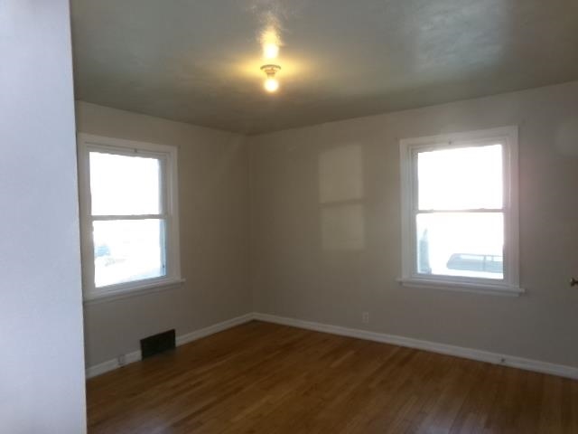 321 West Garfield Street Freeport, IL 61032 - Photo 6 of 11 an empty room with wooden closet and windows