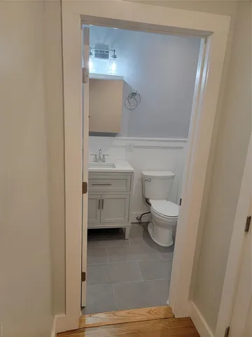 a bathroom with a toilet a sink and mirror
