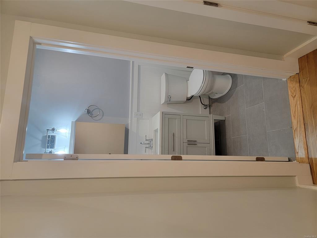 731 Broadway, Unit 2 Valhalla, NY 10595 - Photo 15 of 27 a bathroom with a toilet a sink and mirror