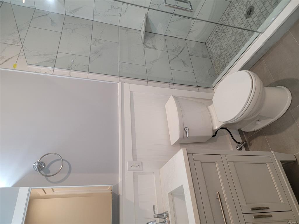 731 Broadway, Unit 2 Valhalla, NY 10595 - Photo 16 of 27 a bathroom with a sink a toilet and shower