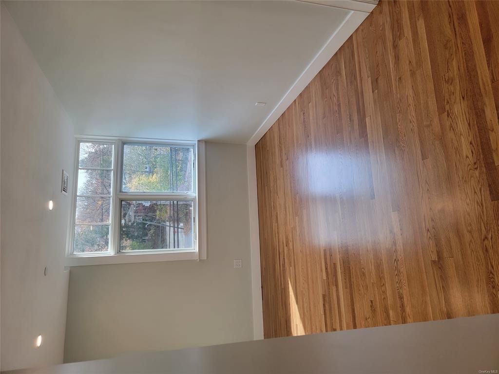 731 Broadway, Unit 2 Valhalla, NY 10595 - Photo 18 of 27 an empty room with wooden floor and windows