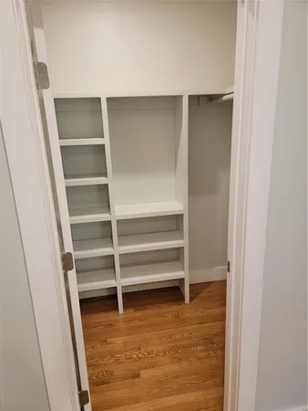 a view of walk in closet with empty racks