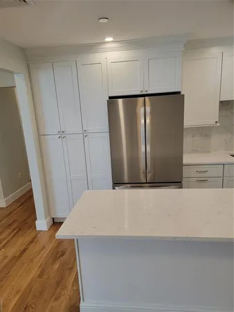 a view of a refrigerator in kitchen and furniture