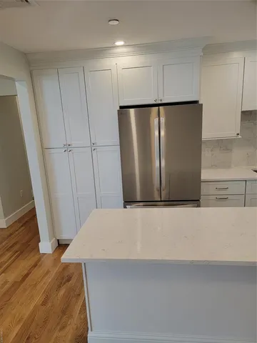 a view of a refrigerator in kitchen and furniture