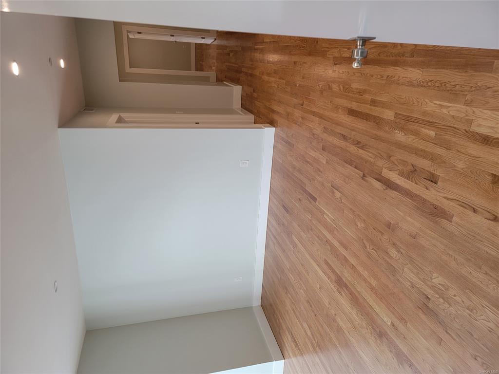 731 Broadway, Unit 2 Valhalla, NY 10595 - Photo 5 of 27 a view of an empty room with wooden floor and a window