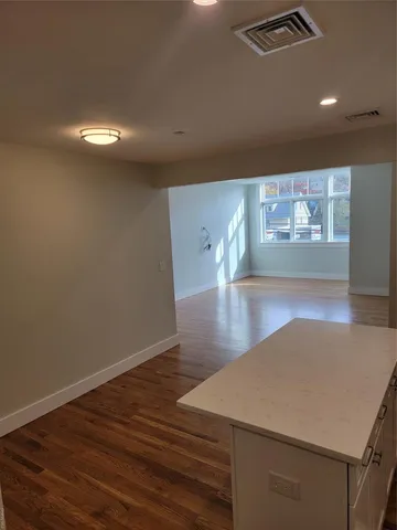 a view of a room with wooden floor