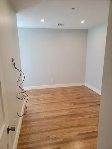 a view of a room with wooden floor