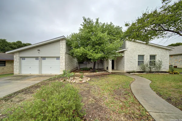 a view of a house with a yard and garage