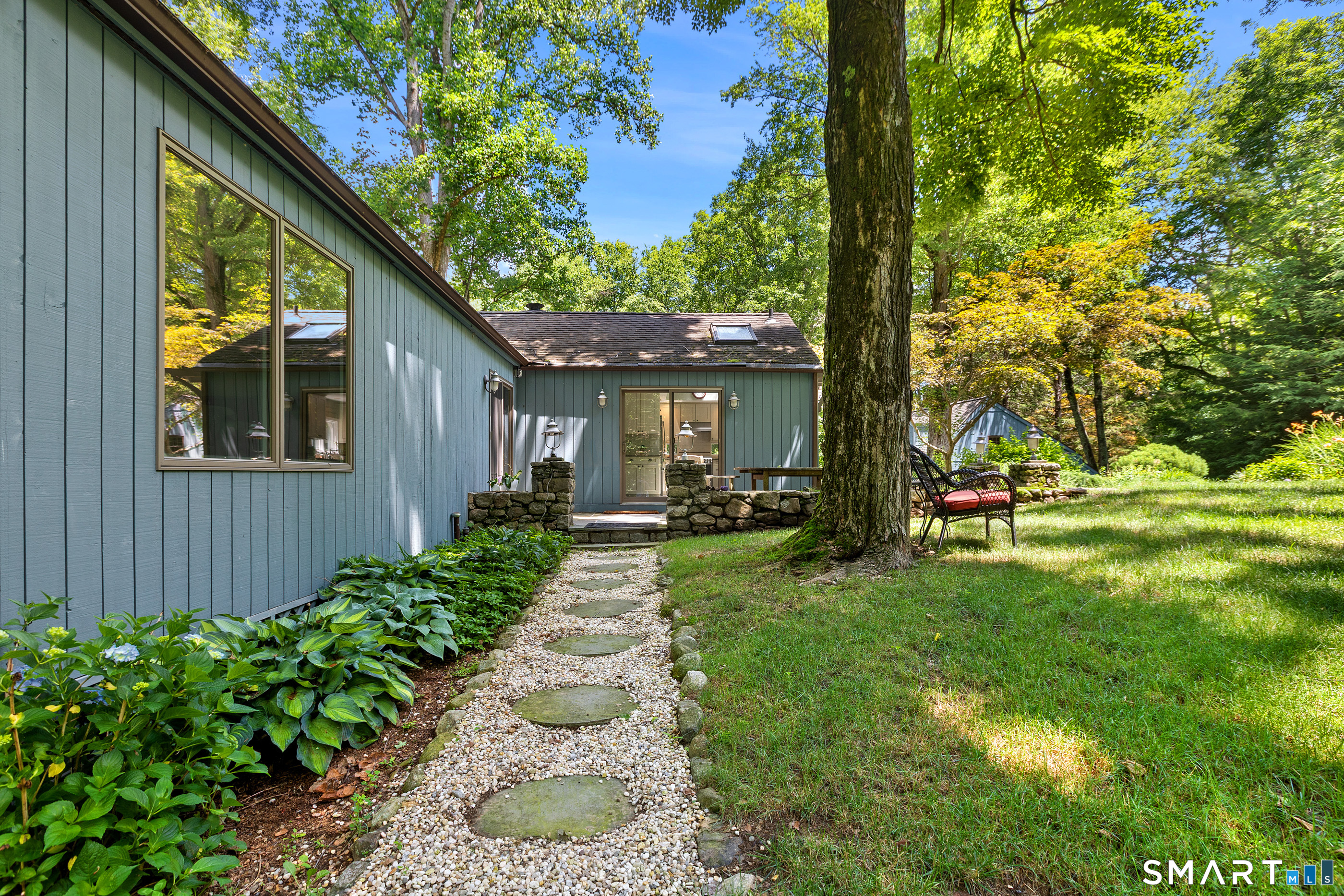 131 Georgetown Road Weston, CT 06883 - Photo 27 of 37 Stone and gravel pathway to Kitchen and Dining Room
