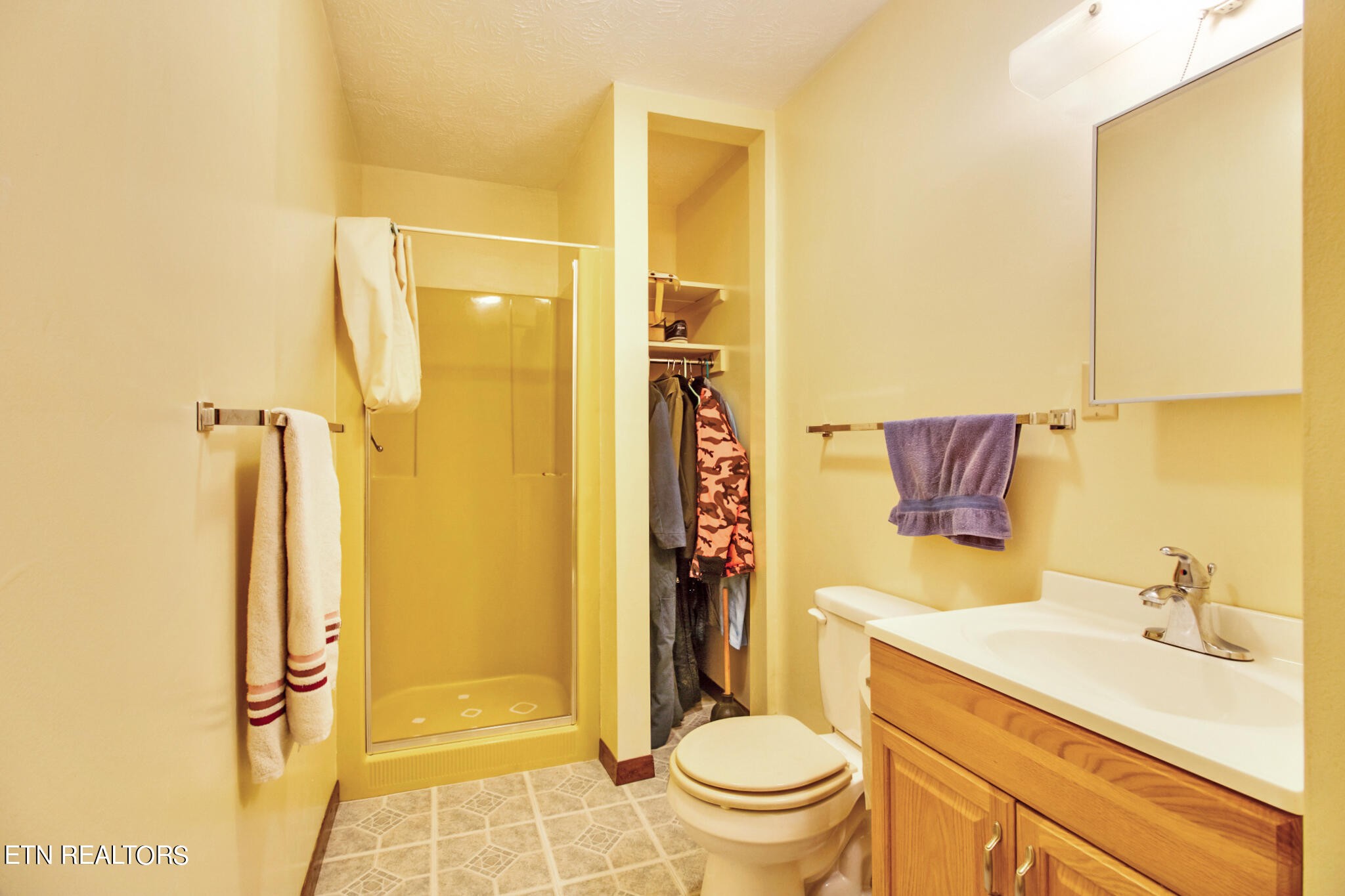 1620 Bell Road Crossville, TN 38571 - Photo 16 of 54 a bathroom with a granite countertop sink toilet and shower