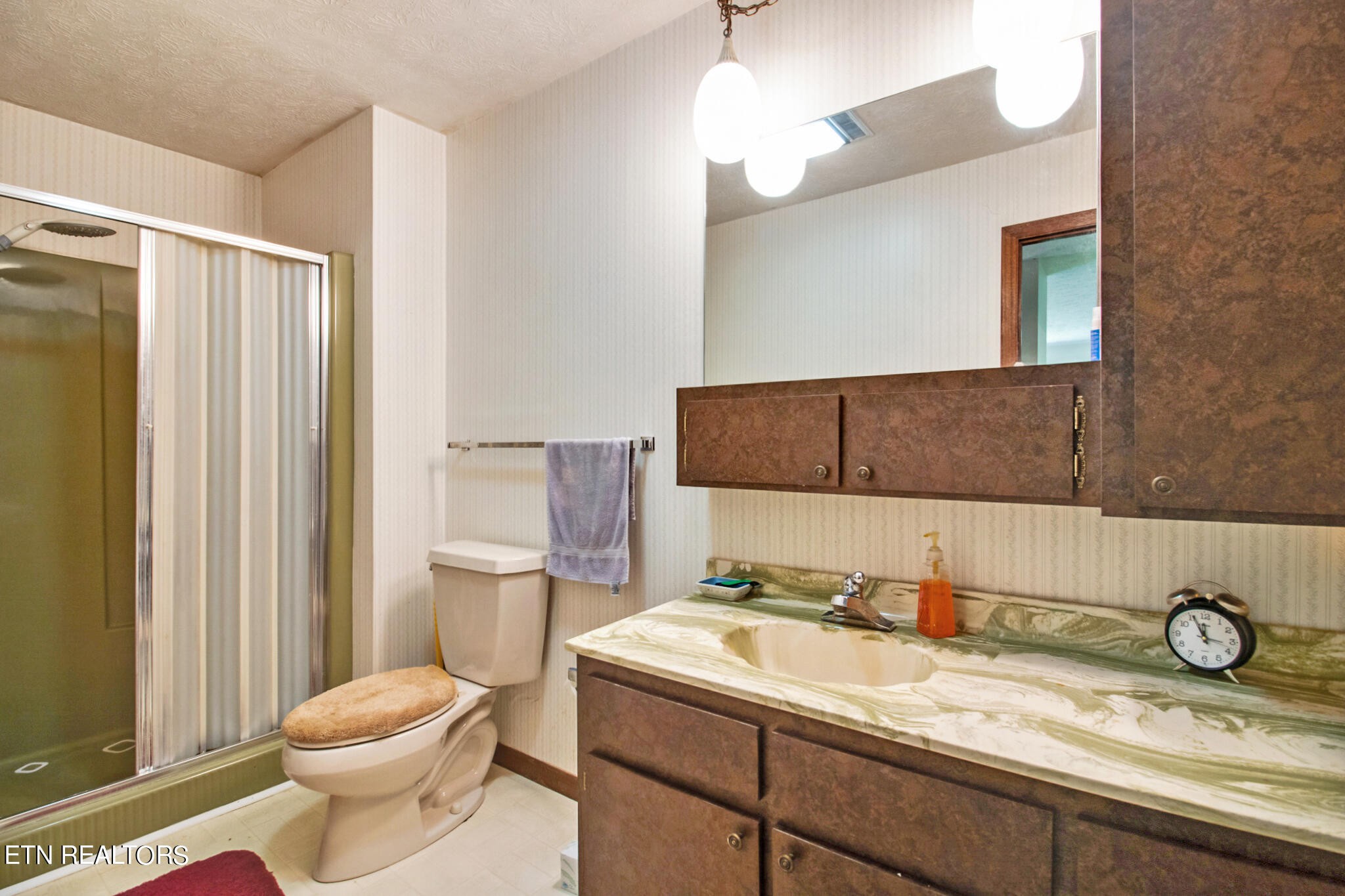 1620 Bell Road Crossville, TN 38571 - Photo 20 of 54 a bathroom with a granite countertop sink toilet and mirror