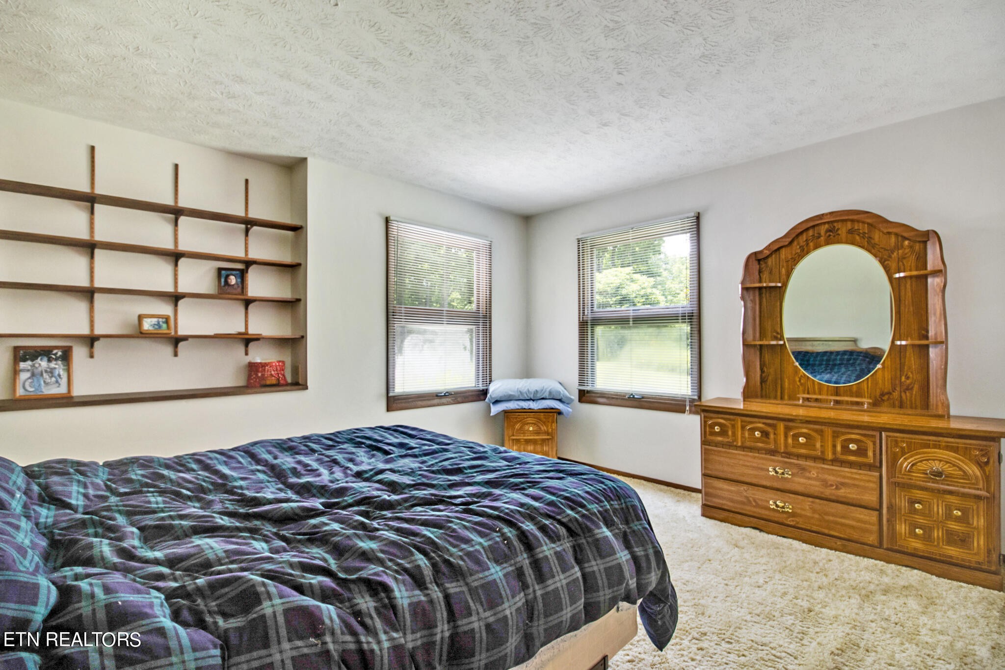 1620 Bell Road Crossville, TN 38571 - Photo 21 of 54 a bedroom with a bed and dresser with mirror