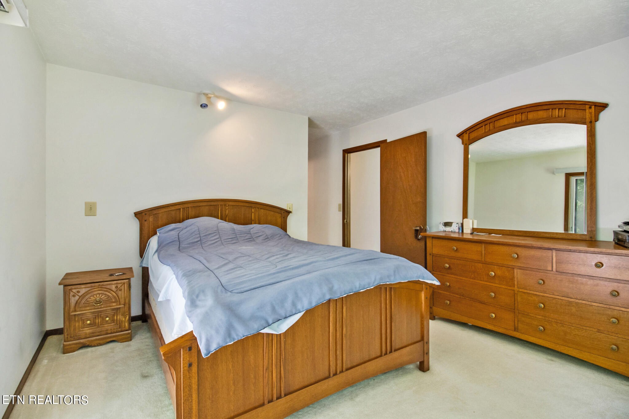 1620 Bell Road Crossville, TN 38571 - Photo 23 of 54 a bedroom with a bed and a dresser with mirror