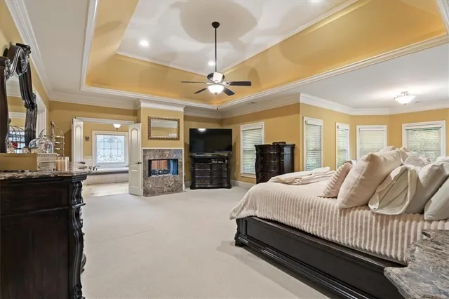 a living room with granite countertop furniture a fireplace and a chandelier