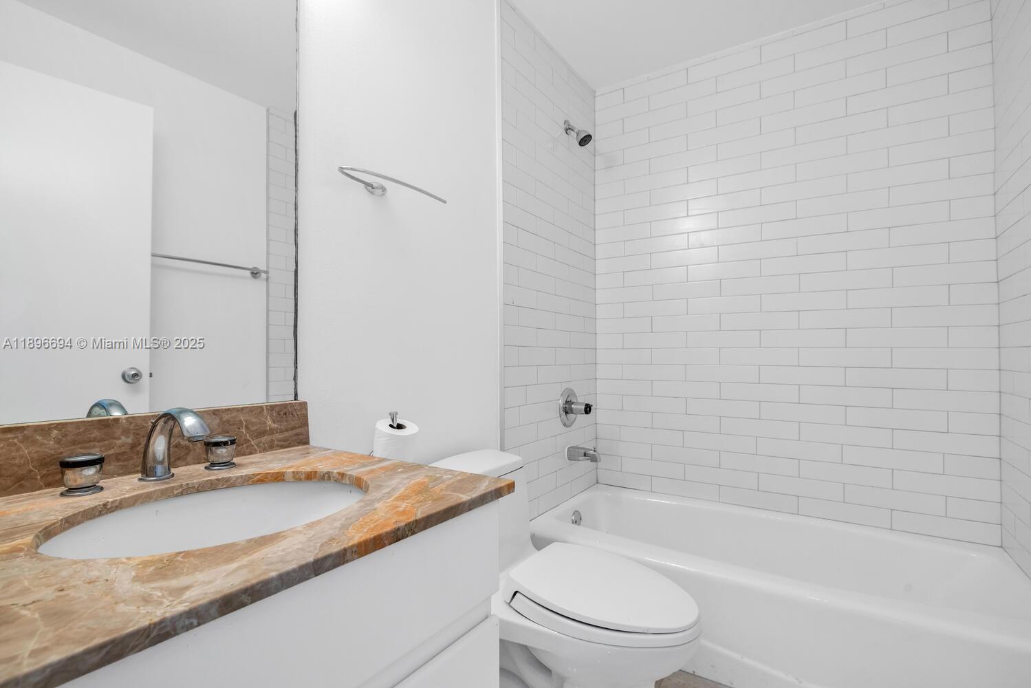 888 Brickell Key Drive, Unit 2607 Miami, FL 33131 - Photo 14 of 43 a bathroom with a granite countertop sink toilet and shower