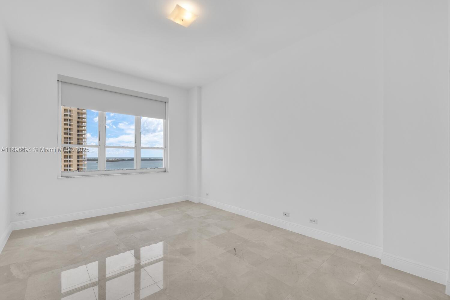 888 Brickell Key Drive, Unit 2607 Miami, FL 33131 - Photo 15 of 43 an empty room with windows
