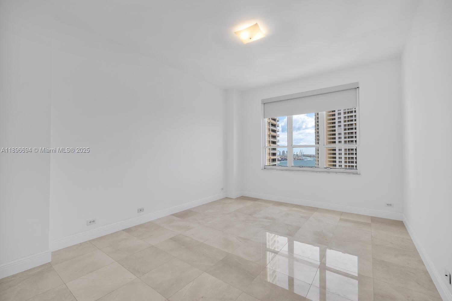888 Brickell Key Drive, Unit 2607 Miami, FL 33131 - Photo 19 of 43 an empty room with windows