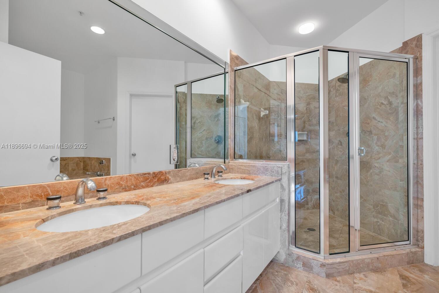 888 Brickell Key Drive, Unit 2607 Miami, FL 33131 - Photo 21 of 43 a bathroom with a granite countertop sink and a mirror