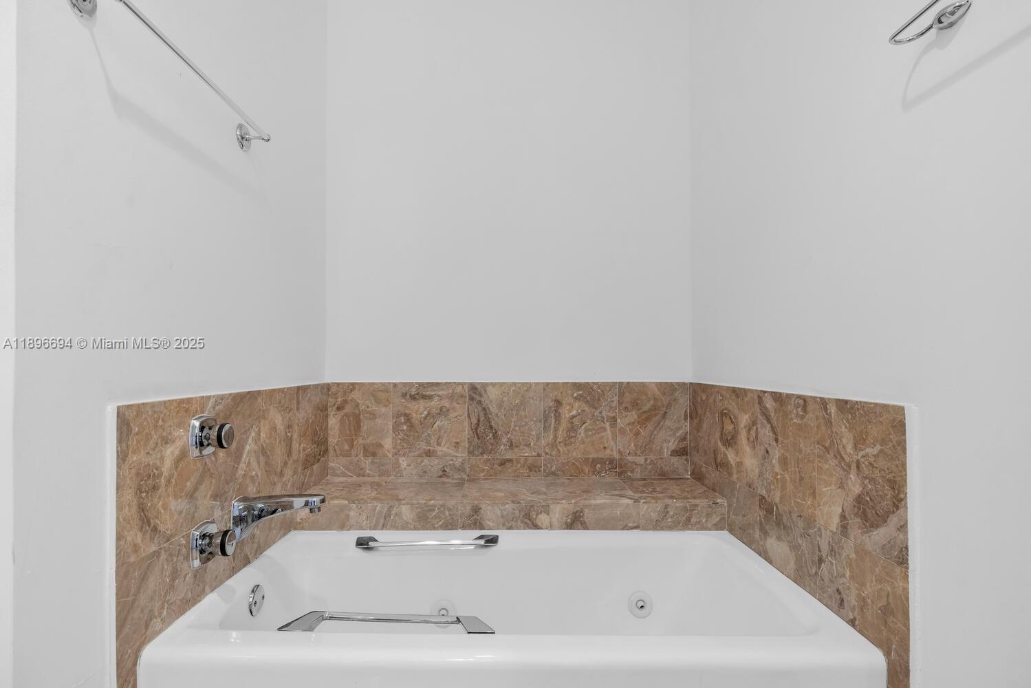 888 Brickell Key Drive, Unit 2607 Miami, FL 33131 - Photo 22 of 43 a view of a bathtub in a bathroom