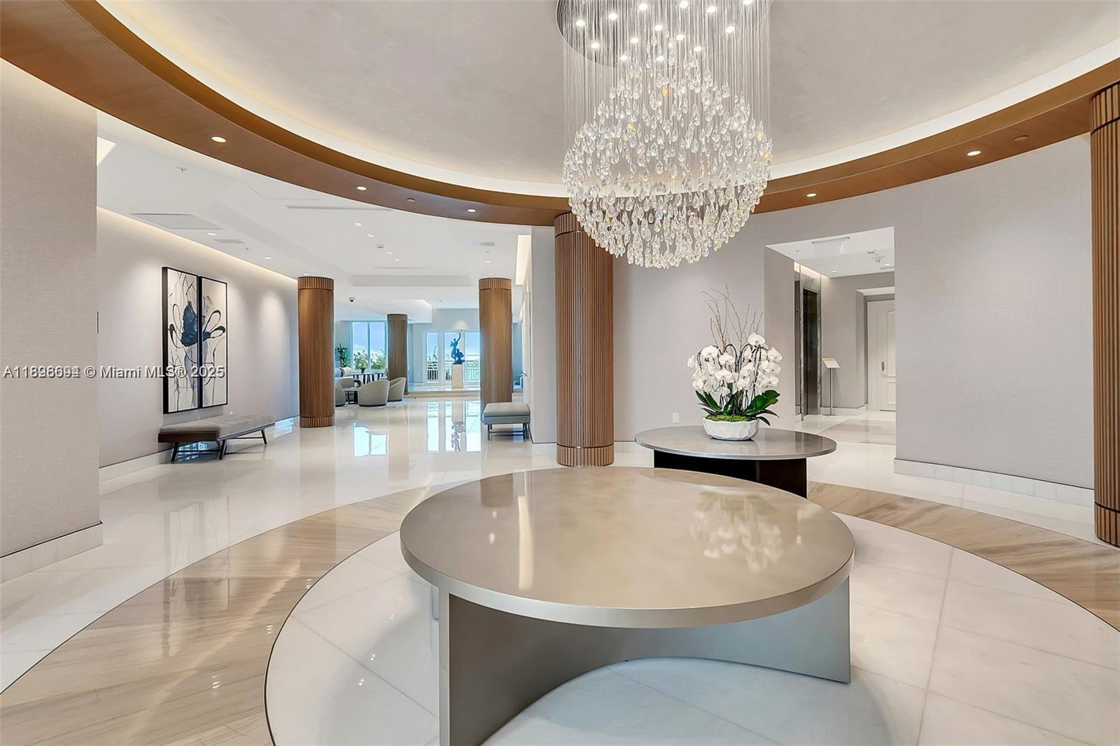 888 Brickell Key Drive, Unit 2607 Miami, FL 33131 - Photo 32 of 43 a living room with furniture and a chandelier