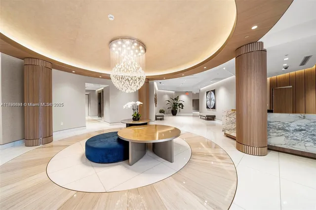 a dining room with glass door and chandelier