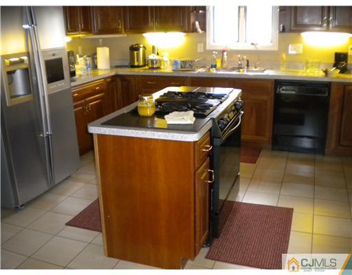 28 Purdue Road Old Bridge, NJ 08859 - Photo 11 of 25 a kitchen with stainless steel appliances granite countertop a stove a refrigerator a sink and dishwasher