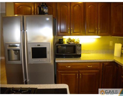 28 Purdue Road Old Bridge, NJ 08859 - Photo 12 of 25 a kitchen with stainless steel appliances kitchen island granite countertop a refrigerator and a stove