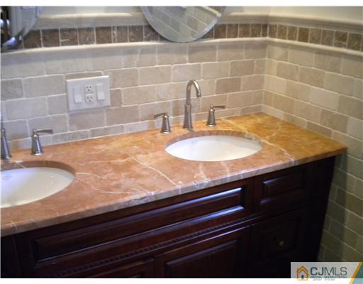 28 Purdue Road Old Bridge, NJ 08859 - Photo 17 of 25 a bathroom with a granite countertop sink a toilet and a mirror