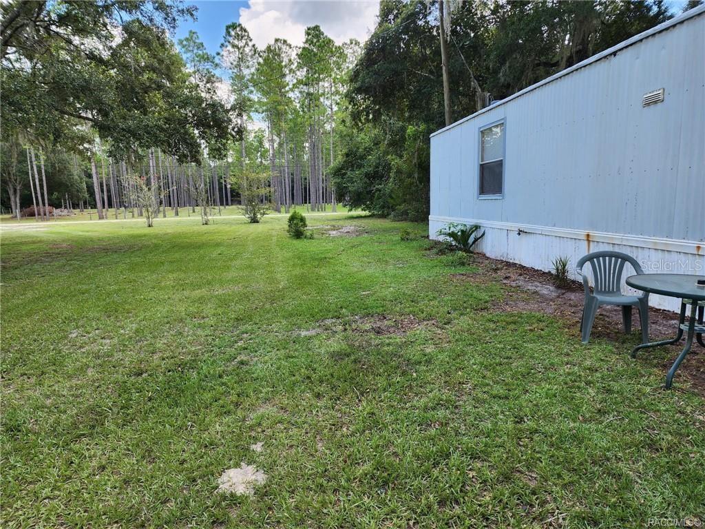 5590 Northwest 76th Avenue Chiefland, FL 32626 - Photo 1 of 22 a view of a house with a backyard