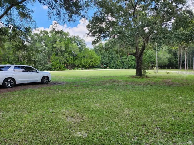 a view of outdoor space with deck and yard