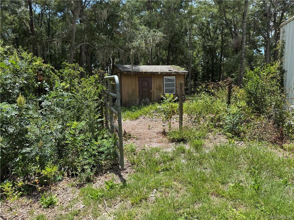 5590 Northwest 76th Avenue Chiefland, FL 32626 - Photo 14 of 22 a view of a house with a yard