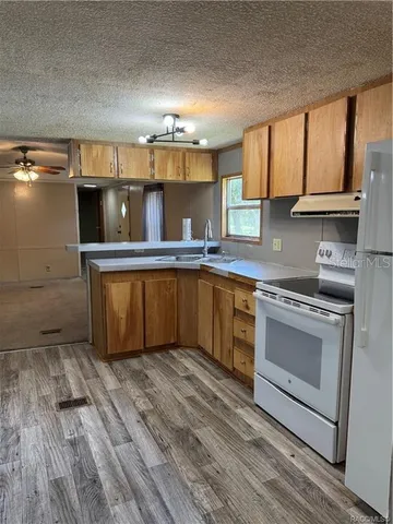 a kitchen with a sink cabinets and appliances