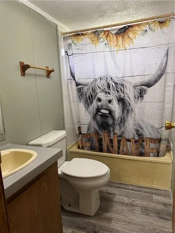 a bathroom with a toilet a sink and bathtub